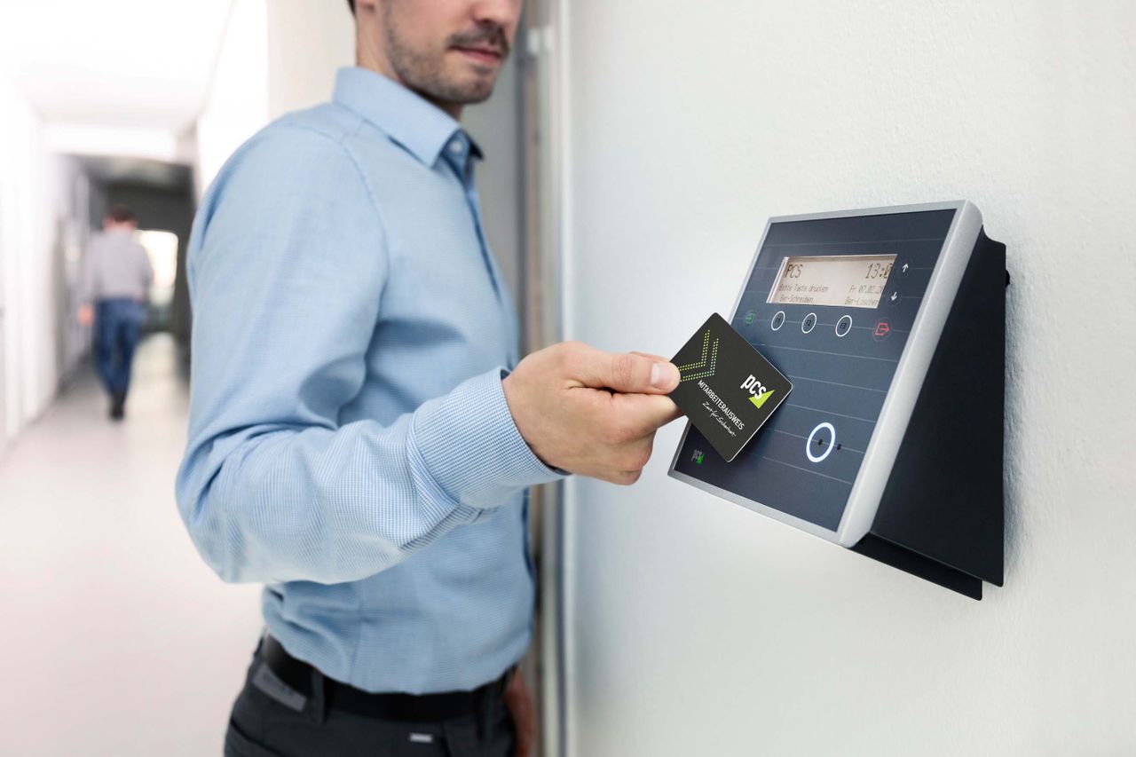 gallery-03 Businessman uses RFID card reader for secure office access, enhancing workplace security.